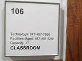 Photo of locy hall room number 106 showing whiteboard from distance