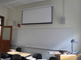 Photo of Locy Hall room number 110 showing whiteboard