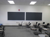 Photo of Locy Hall room number 111 showing two blackboards