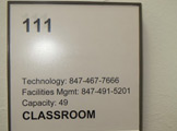Photo of Locy Hall room number 111 label outsided the room