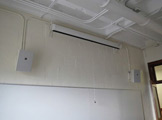 Photo of locy Hall Room Number 213 showing a projector mounted on the ceiling 