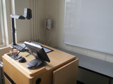 another view of locy Hall Room Number 213 showing teachers desk