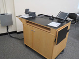 Photo of locy Hall Room Number 214 shoiwng a podium