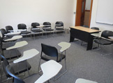 Photo of locy hall room number 305 showing chairs and a desk