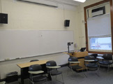 Photo of locy hall room number 314 showing a whiteboard and a window
