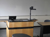 Photo of locy hall room number 318 showing podium