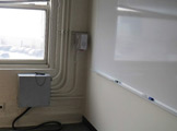 Photo of locy hall room number 318 showing phone on the wall
