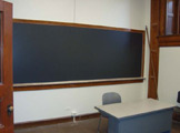 View of blackboard and table.