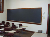 View of blackboard and seats. 