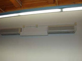 Florescent light with wall-mounted equipment.