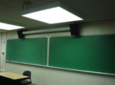 View of blackboard and florescent lights.
