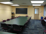 View of classroom seating: large table with chairs.