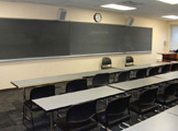 Rows of tables and blackboard.