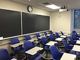 2 blackboards and several student chairs