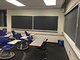 student chairs and blackboard