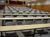 Auditorium seating with rows of tables.