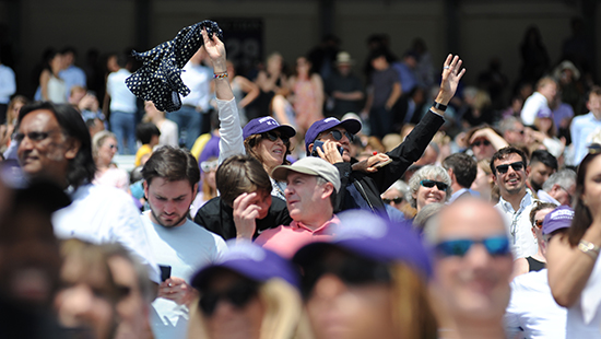 parents waving in the crowd at commencement