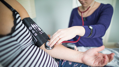 nurse midwife with pregnant patient