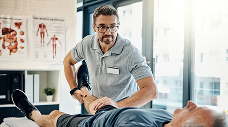 physical therapist with older patient