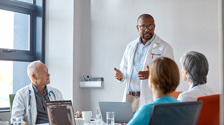 public health professional speaking to group in meeting