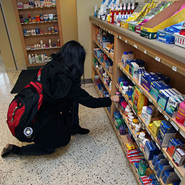 Student checking out the various non-prescription products available at the Health Service Pharmacy