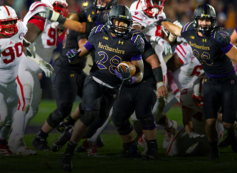 A football player running with the ball