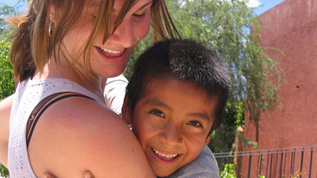 Student hugging child