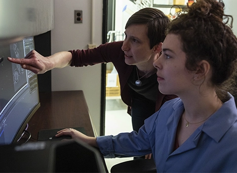 Two women looking at the computer screen