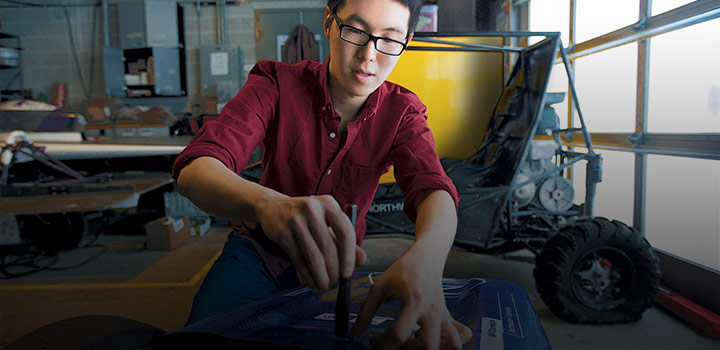 student working on a vehicle