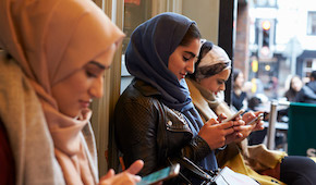 A photo of Qatar students that are using cellphone