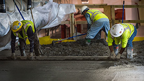 Construction workers pouring concrete