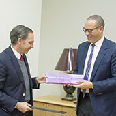 Universidad Panamericana Campus Mexico President Santiago García Álvarez and Northwestern Provost Jonathan Holloway exchanging a purple package