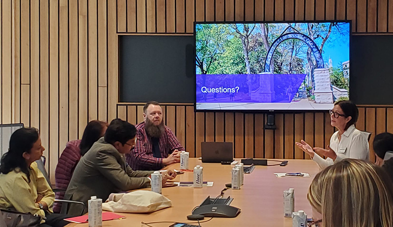 Sandrine Oneyise with the Kellogg School of Management speaking with participants of the Fulbright-Nehru International Education Administrators Program at a conference table.