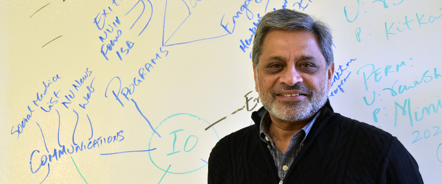 Northwestern's Ravi Shankar in front of wall with writing in his office.