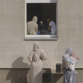 Women stand outside a window