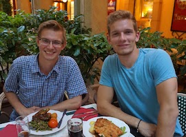 Robert Babich and John Gustafson enjoy a meal in Berlin.