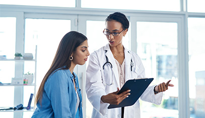 doctor showing patient something on clipboard