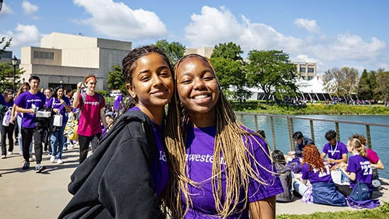 two female students smiling and hugging