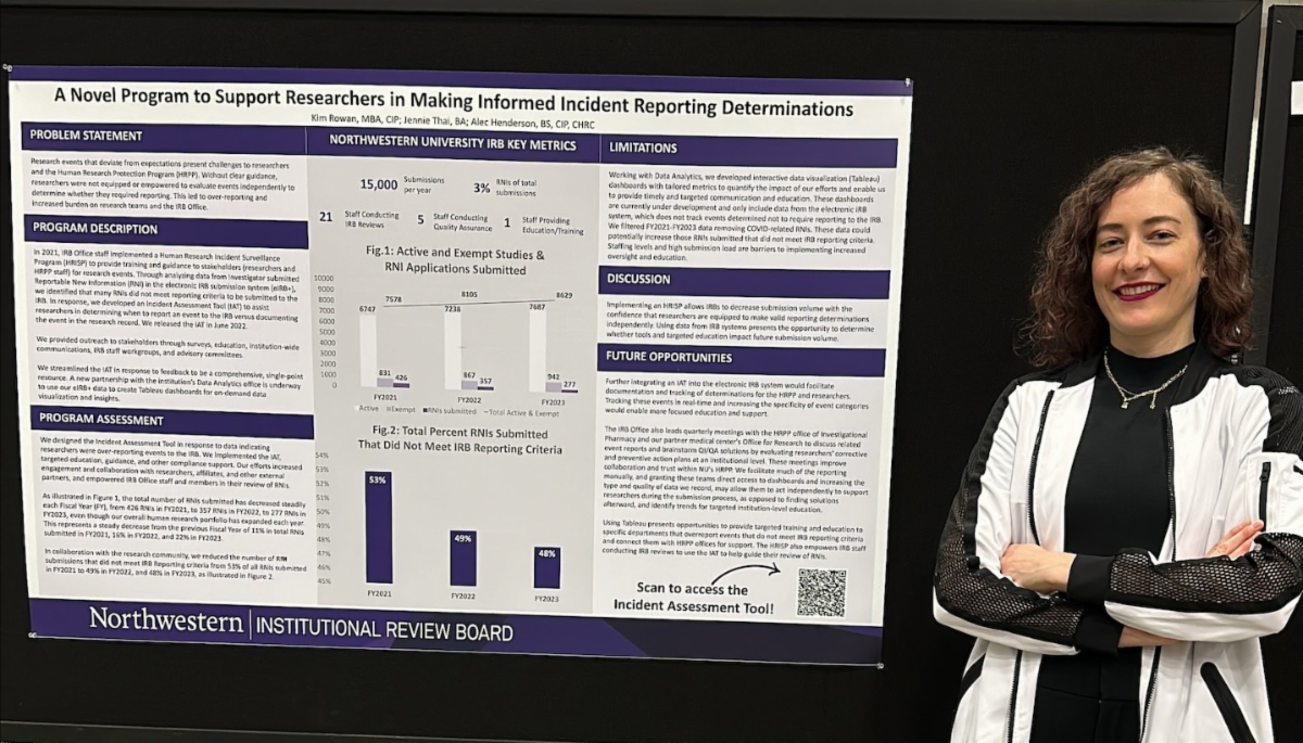 A person stands beside an academic poster