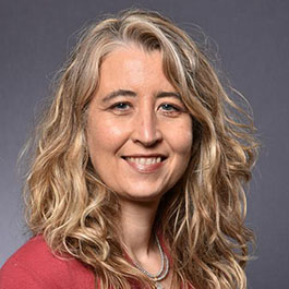 woman with blonde curly hair smiling