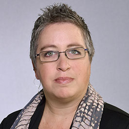 woman with short gray hair and glasses