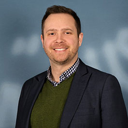 man with brown hair smiling