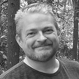 man with white hair and beard smiling