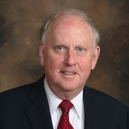 man in black suit smiling