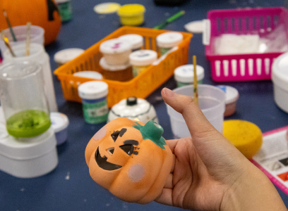 person painting pumpkin bisque