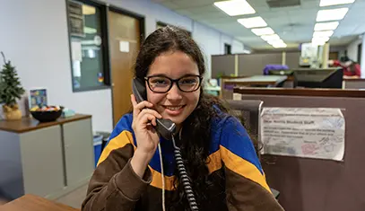 student on the phone, smiling