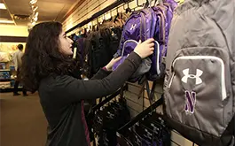 woman hanging backpacks