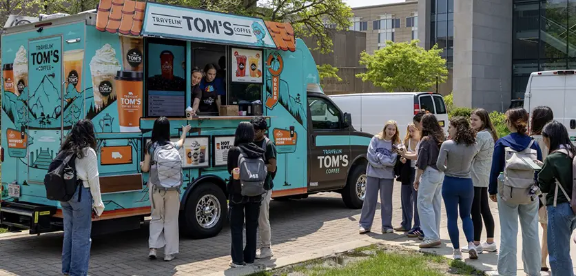 students waiting in line to a food truck