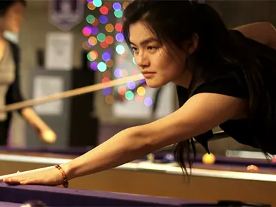 a woman playing pool
