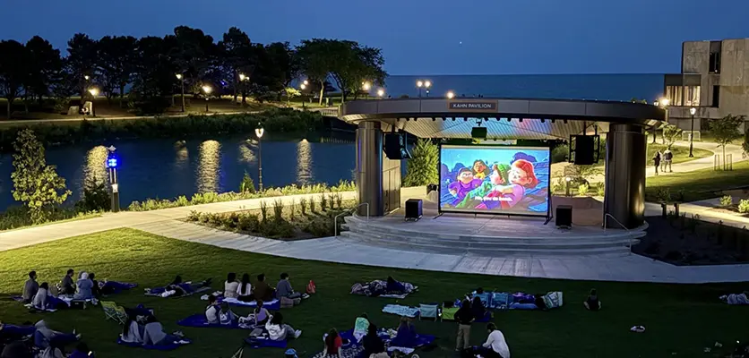 a cinema screen on campus showing a movie